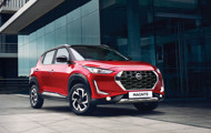 Red Nissan Magnite in front of building